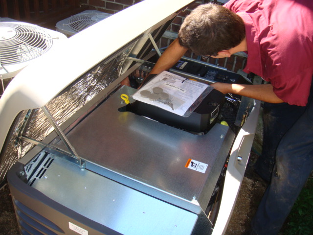 NSE workers doing a service on a generator.